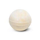 A round, pale yellow bath bomb on a white background.