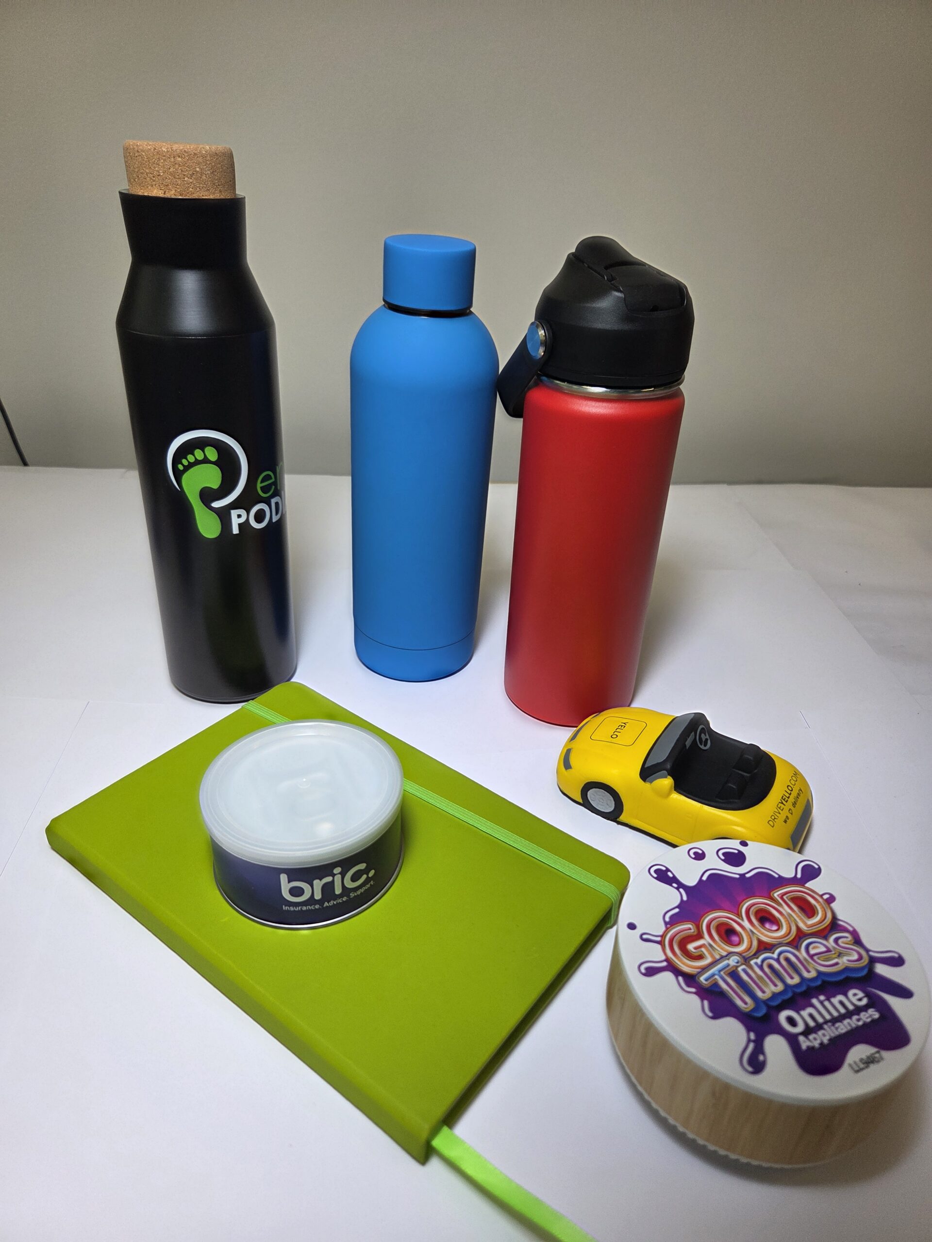 Three water bottles, green notebook, toy car—showcasing the fuel price impact on daily essentials.