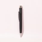 A black retractable pen with a silver tip and clip on a light pink background.
