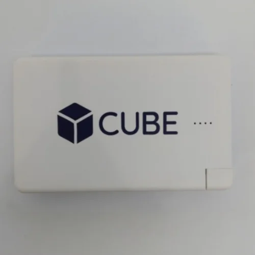 White rectangular device labeled CUBE with a cube icon and four dots on its surface.