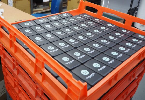 Orange crate with Heathkit boxes in a warehouse; minimum order quantities explained.