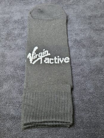 A gray sock with Virgin Active logo printed using EPS file format on a textured gray surface.