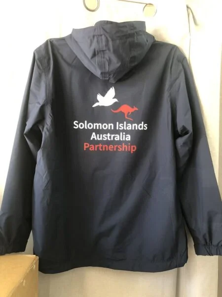 Navy jacket featuring Solomon Islands Australia Partnership and animal logos—event merchandise Australia.