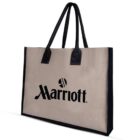 Beige tote bag with black handles and a black Marriott logo on the front.