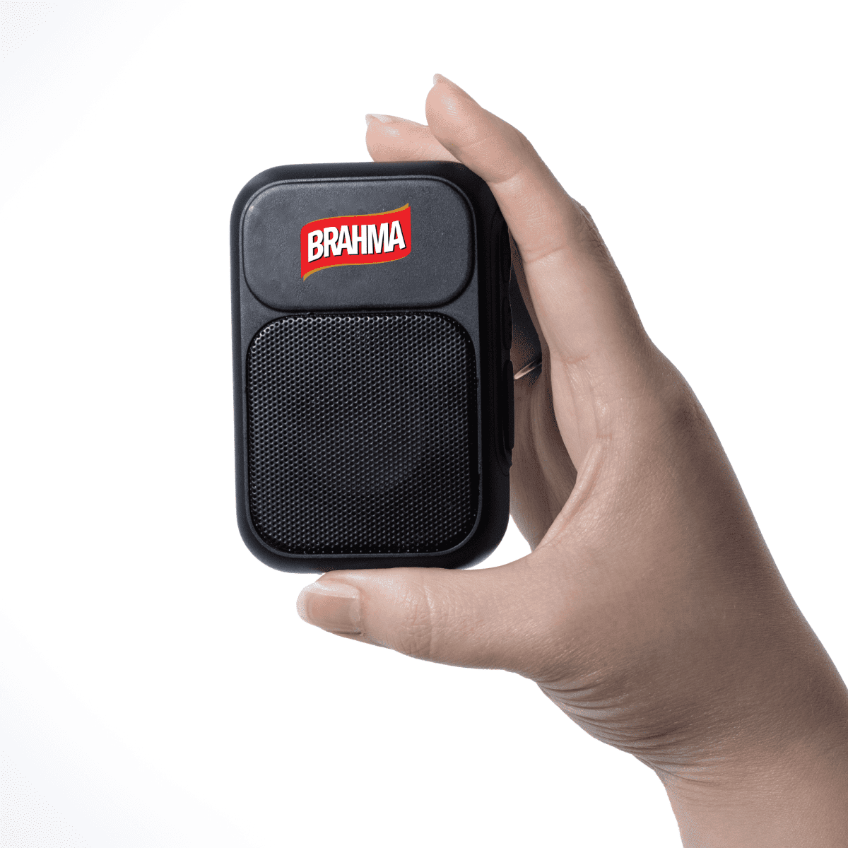 A hand holds a small black device with a Brahma logo on it against a white background.