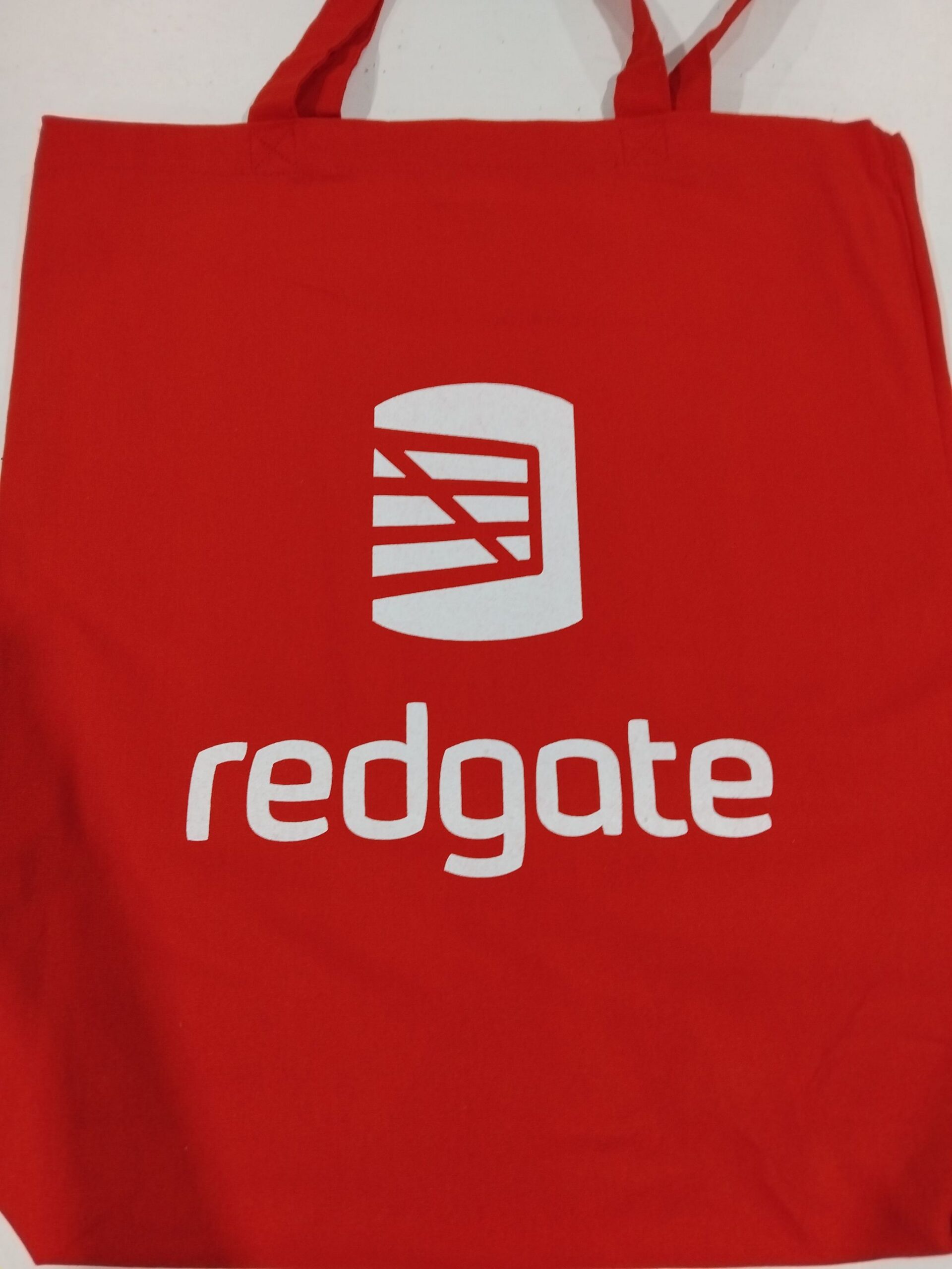 Red tote bag with white redgate logoβperfect event and tradeshow swag for any occasion.