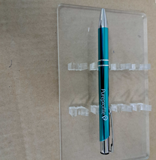 A turquoise Pureprofile pen on a clear plastic stand—perfect for capturing your next Client Story.