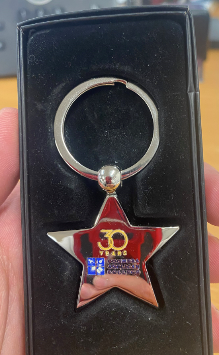 A star-shaped keychain engraved with 30, Cooper Alfred Coulter, Coomera Anglican College.