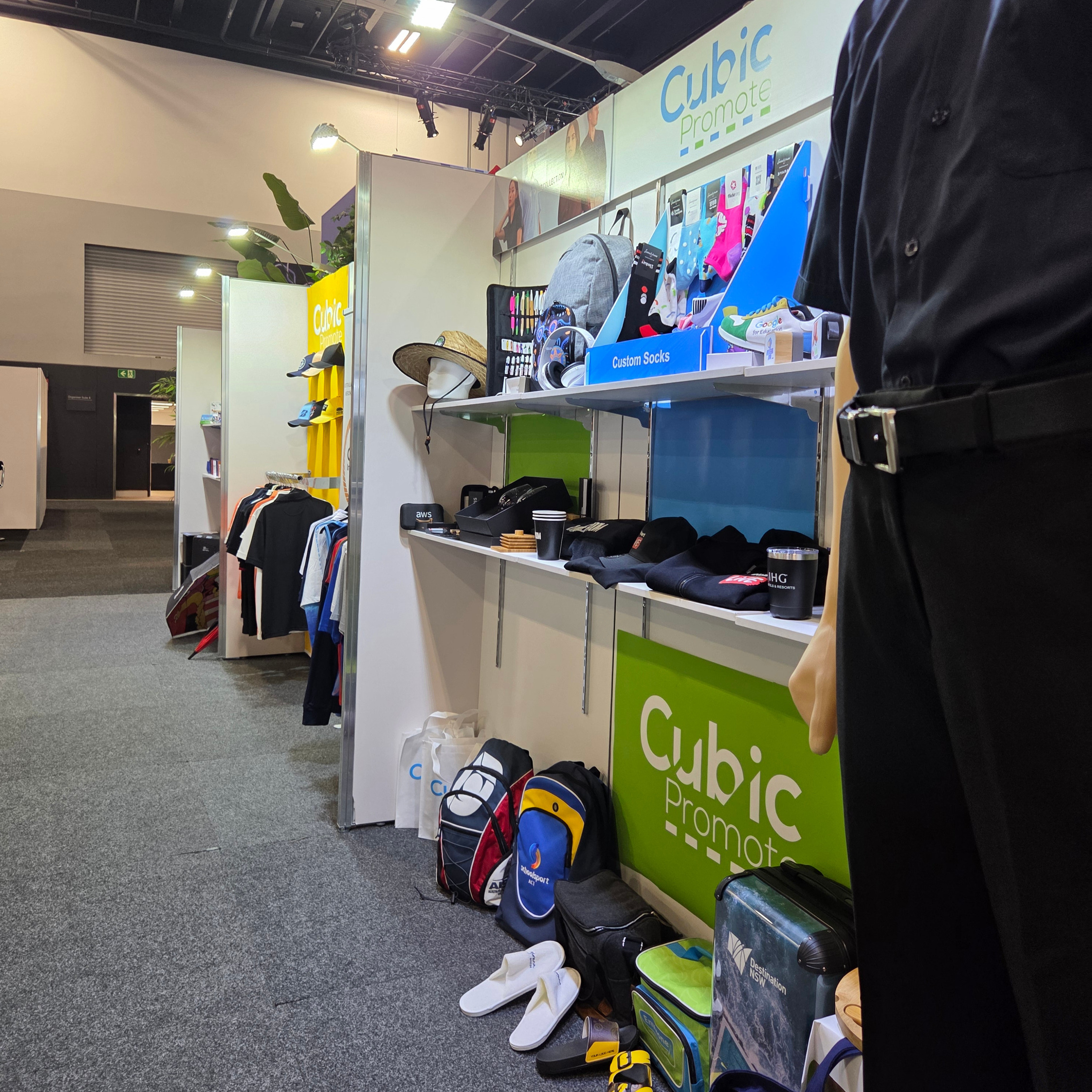 Trade show booth showcasing products for trade shows like branded bags, shirts, hats, and socks.
