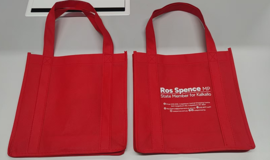 Two red tote bags, perfect for government teams or election orders, on a white surface.