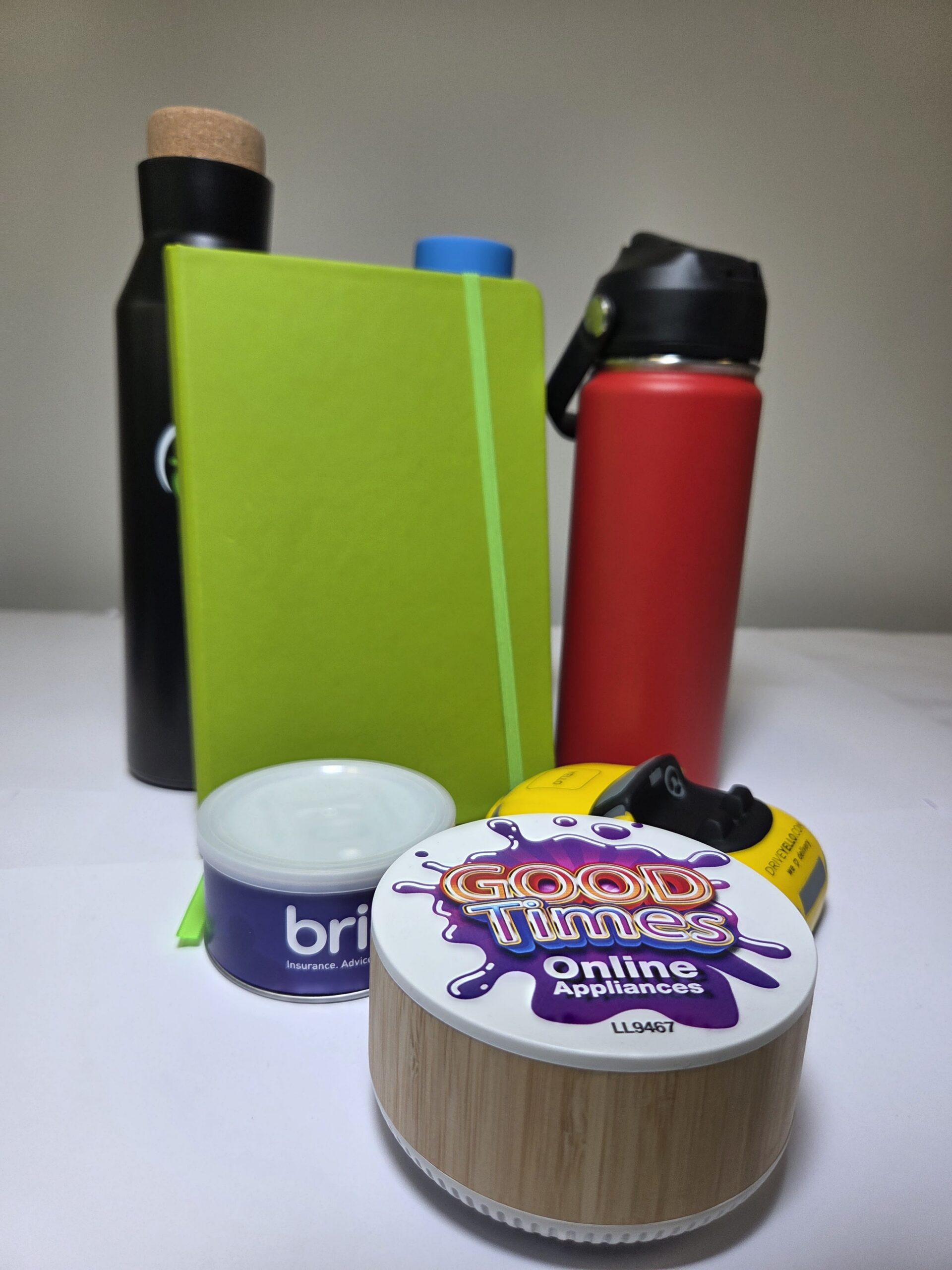 Green notebook, two water bottles, tin, and a container for an End Of Financial Year 2026 clear out.