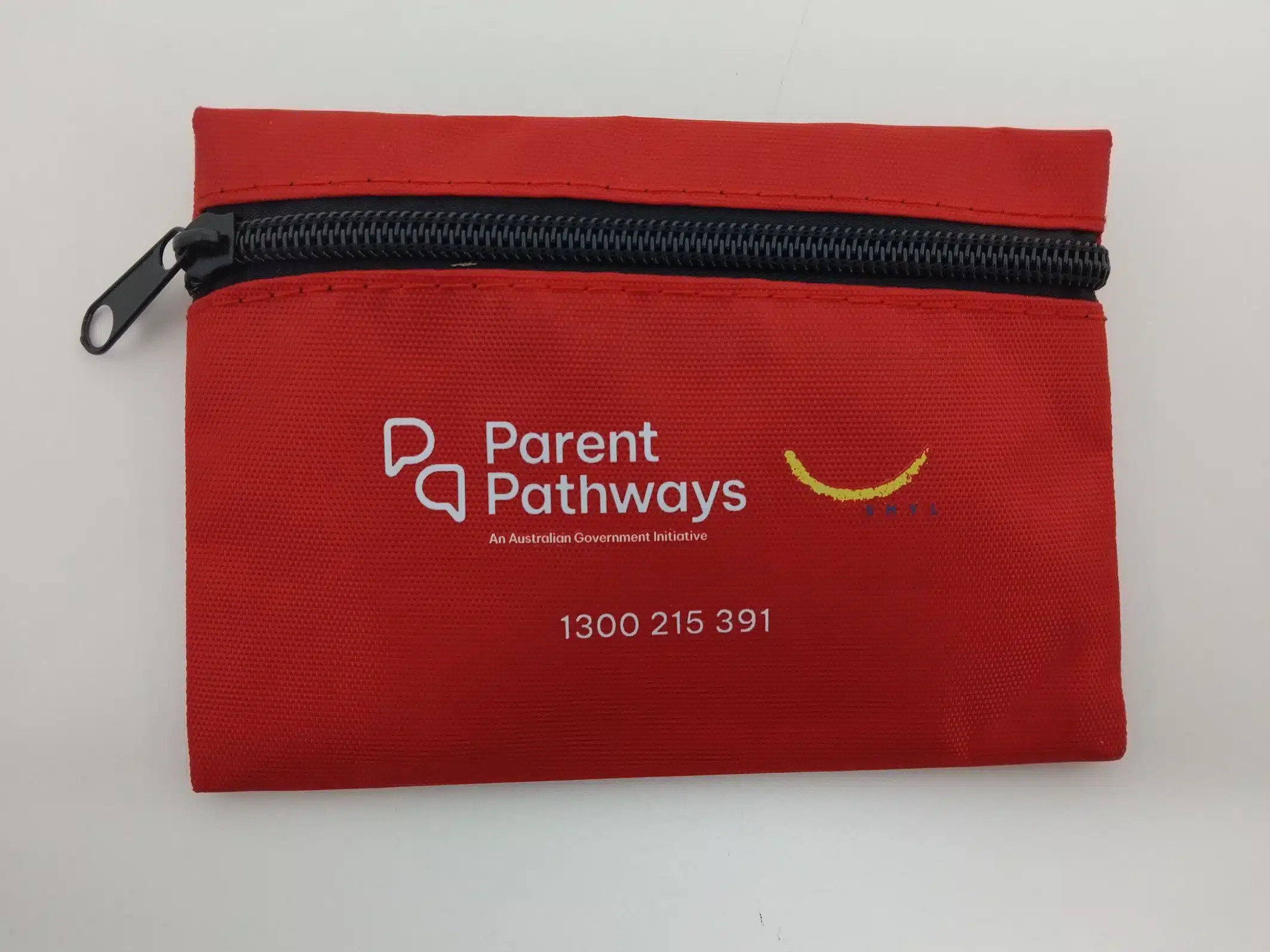 Red zippered pouch with SMYL logo, Parent Pathways info, and phone number on the front.
