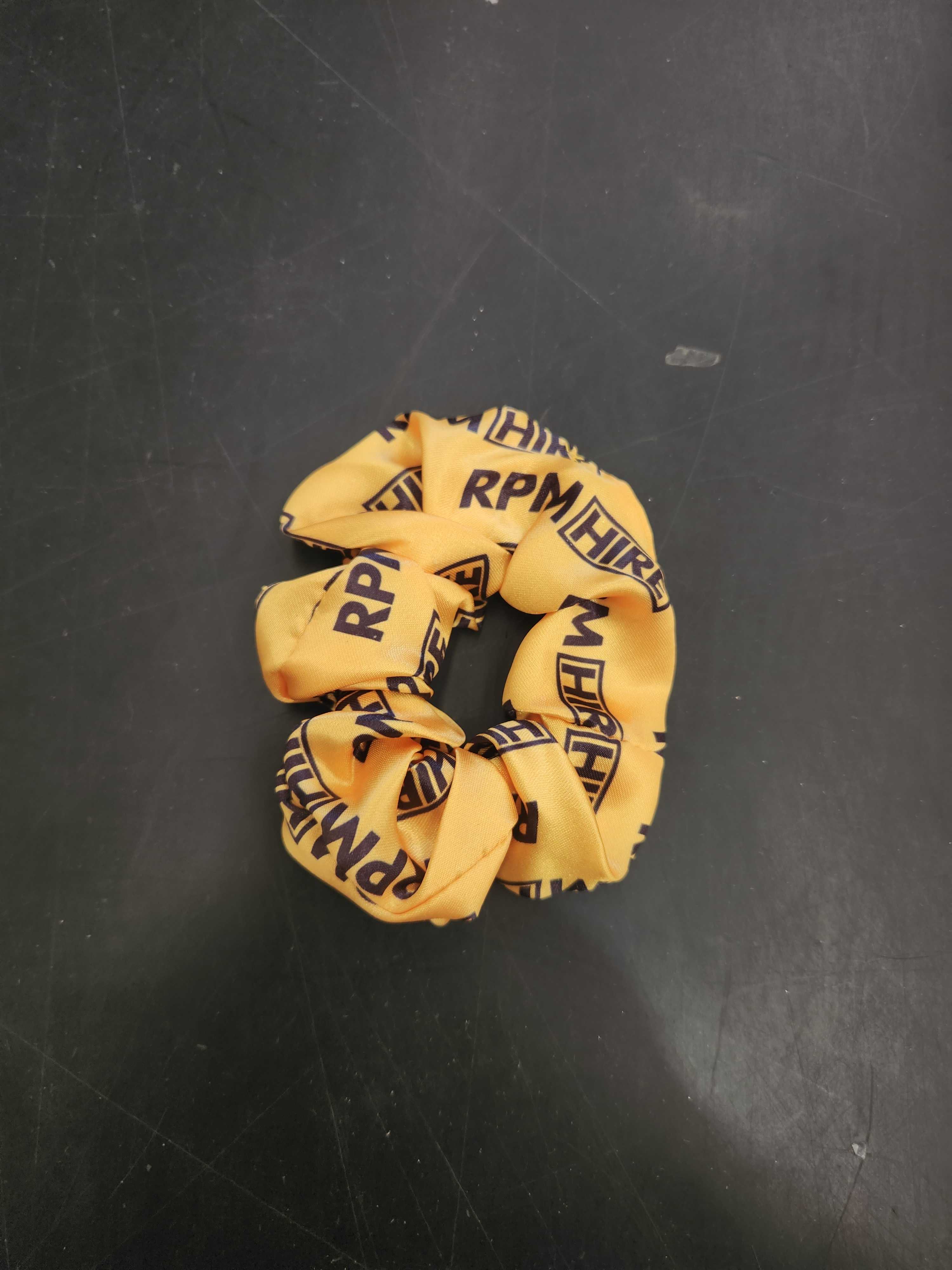 yellow scrunchie with RPM hire logo