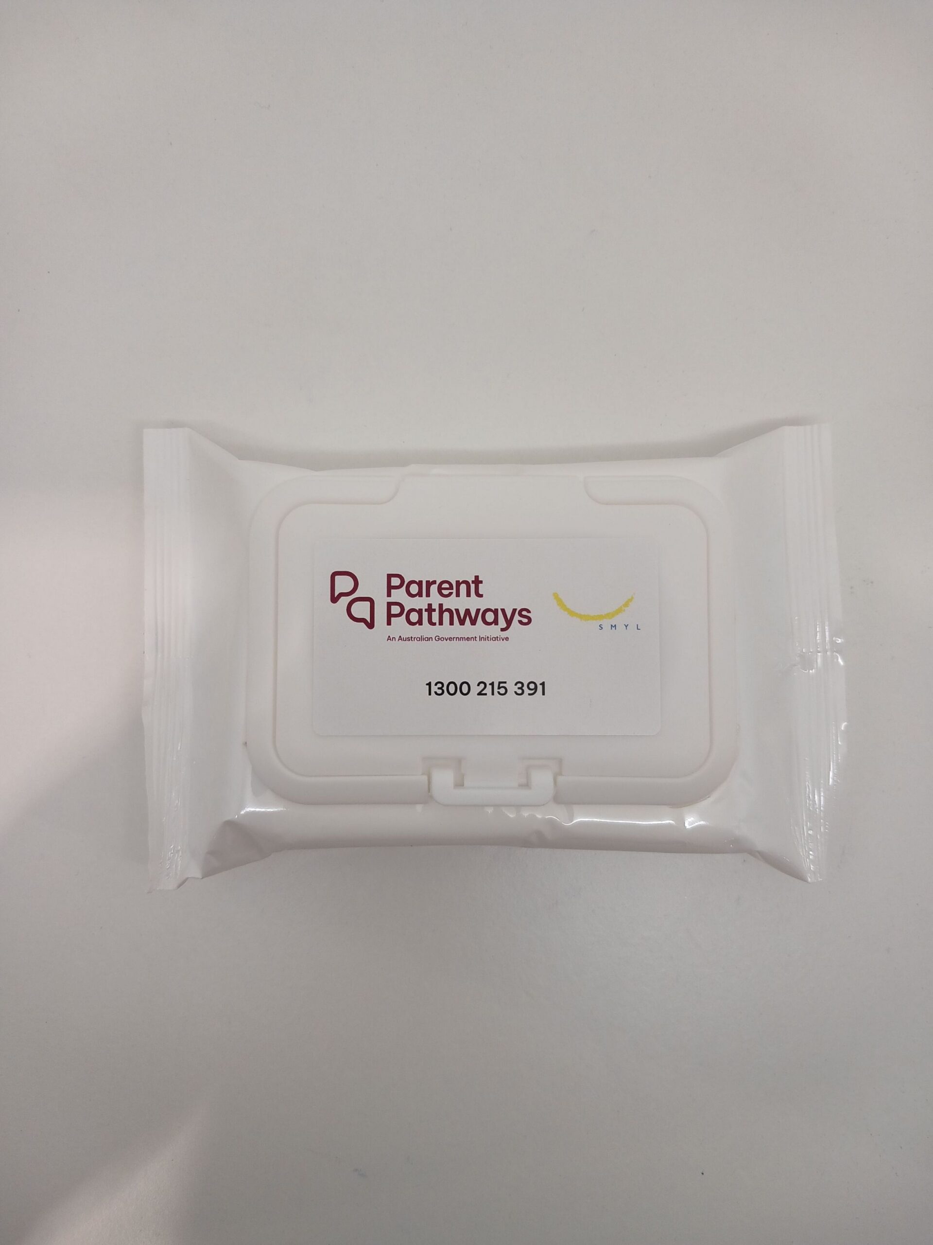 White packet of SMYL wipes labeled Parent Pathways with a phone number on a white surface.