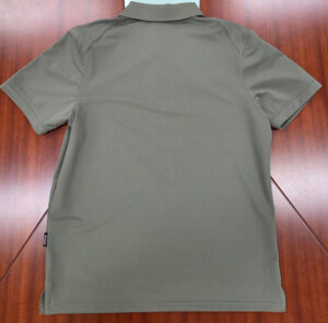 back of a grey polo shirt on a wooden table