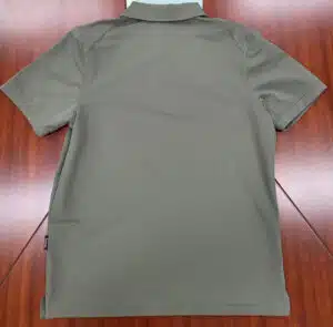 back of a grey polo shirt on a wooden table