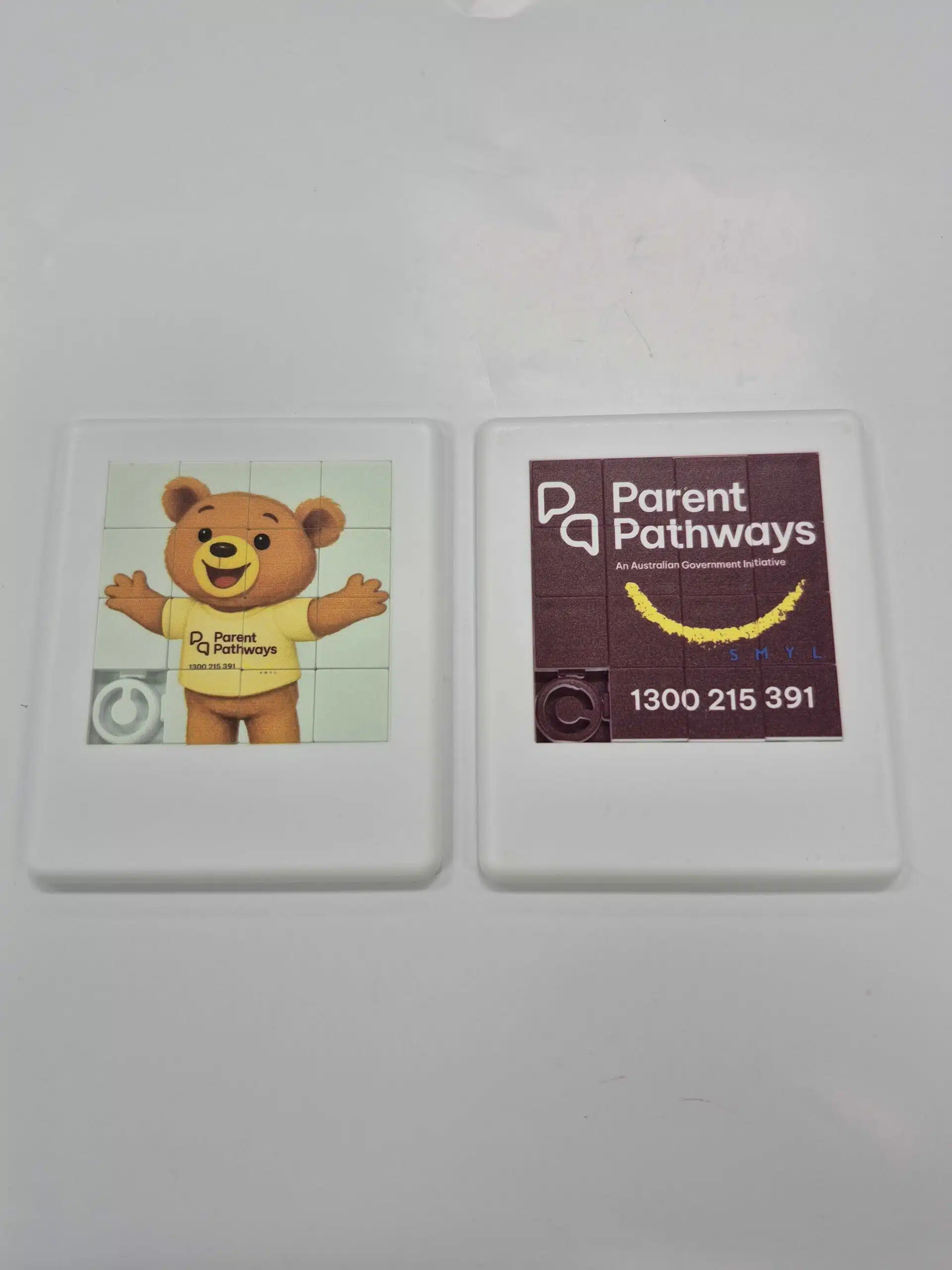 Two Parent Pathways fridge magnets for SMYL—a teddy bear and satisfied client contact details.
