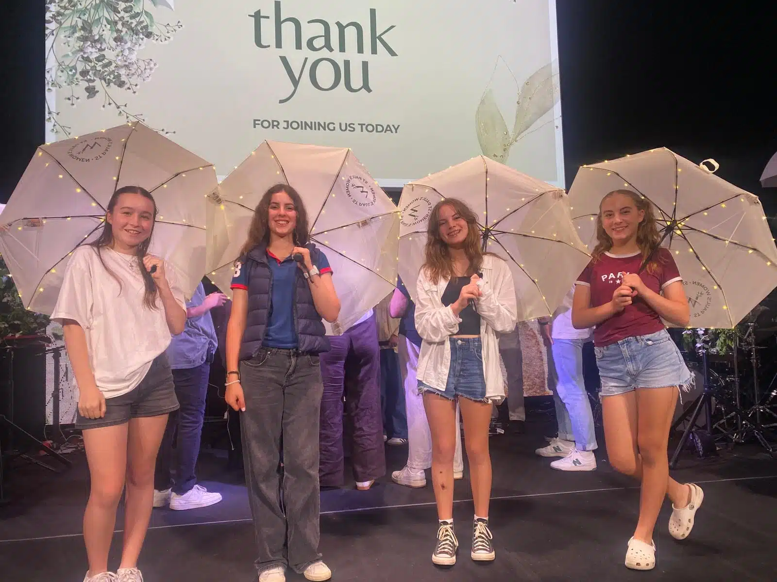 St. Paul’s Castle Hill attendees holding branded LED fairy-light umbrellas