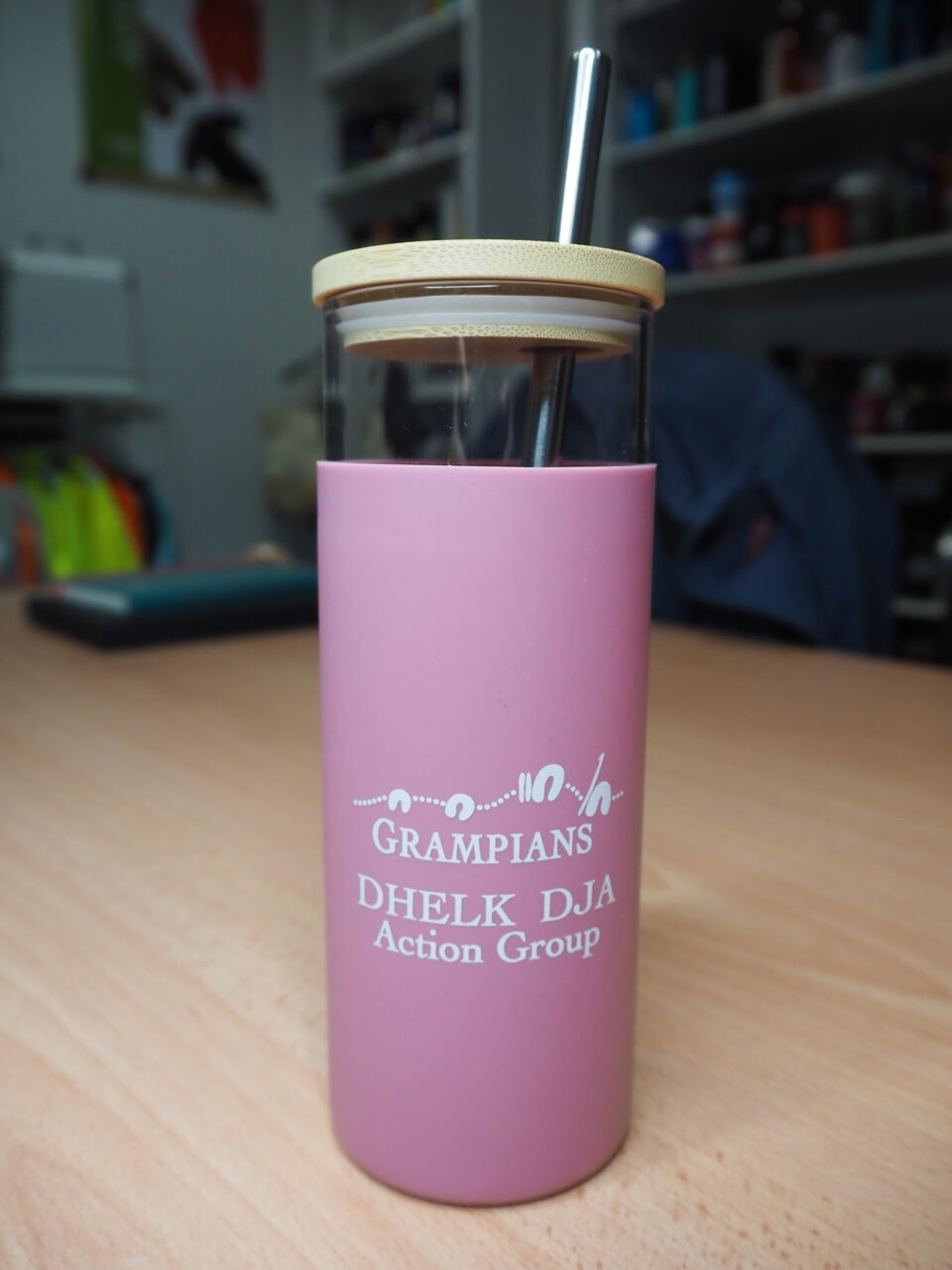 drink bottle with wooden lid and a straw
