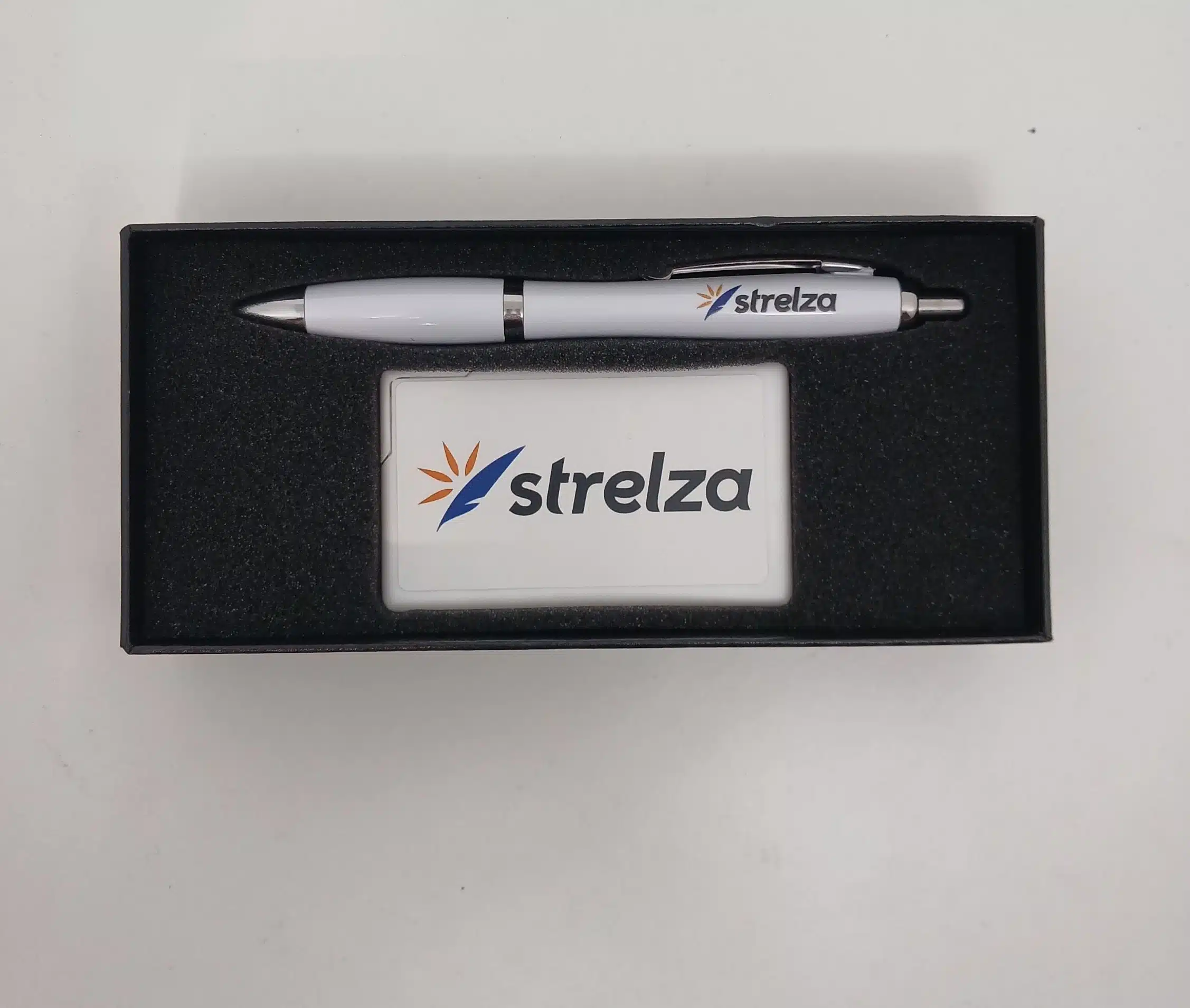 white pen and mint in a black box with strelza logo