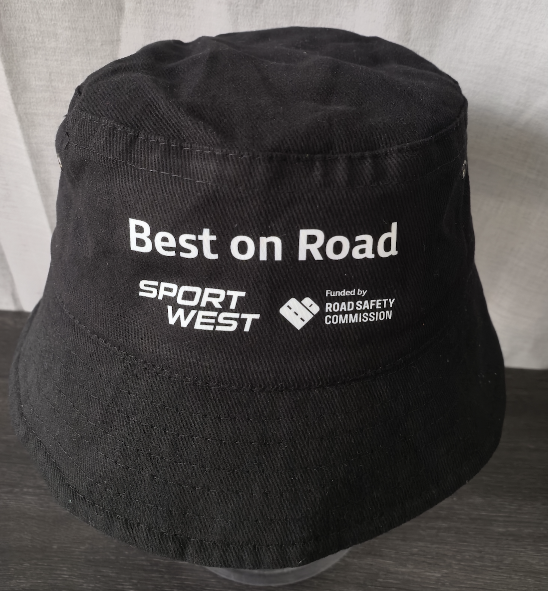 black bucket hat with best on road text and logos embroidered