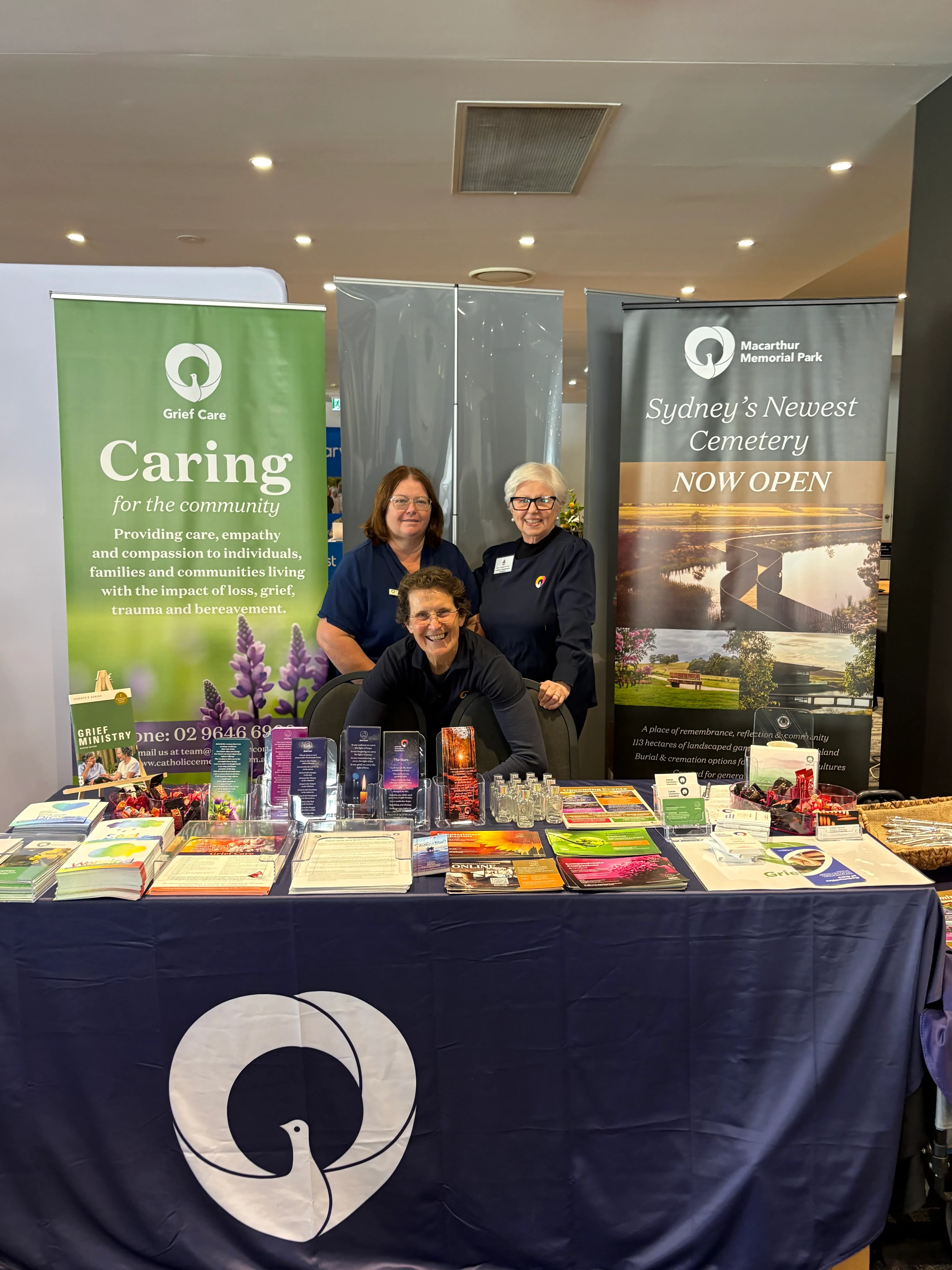 The Grief Care stall at the 2026 Clergy Conference with the branded notebooks on display
