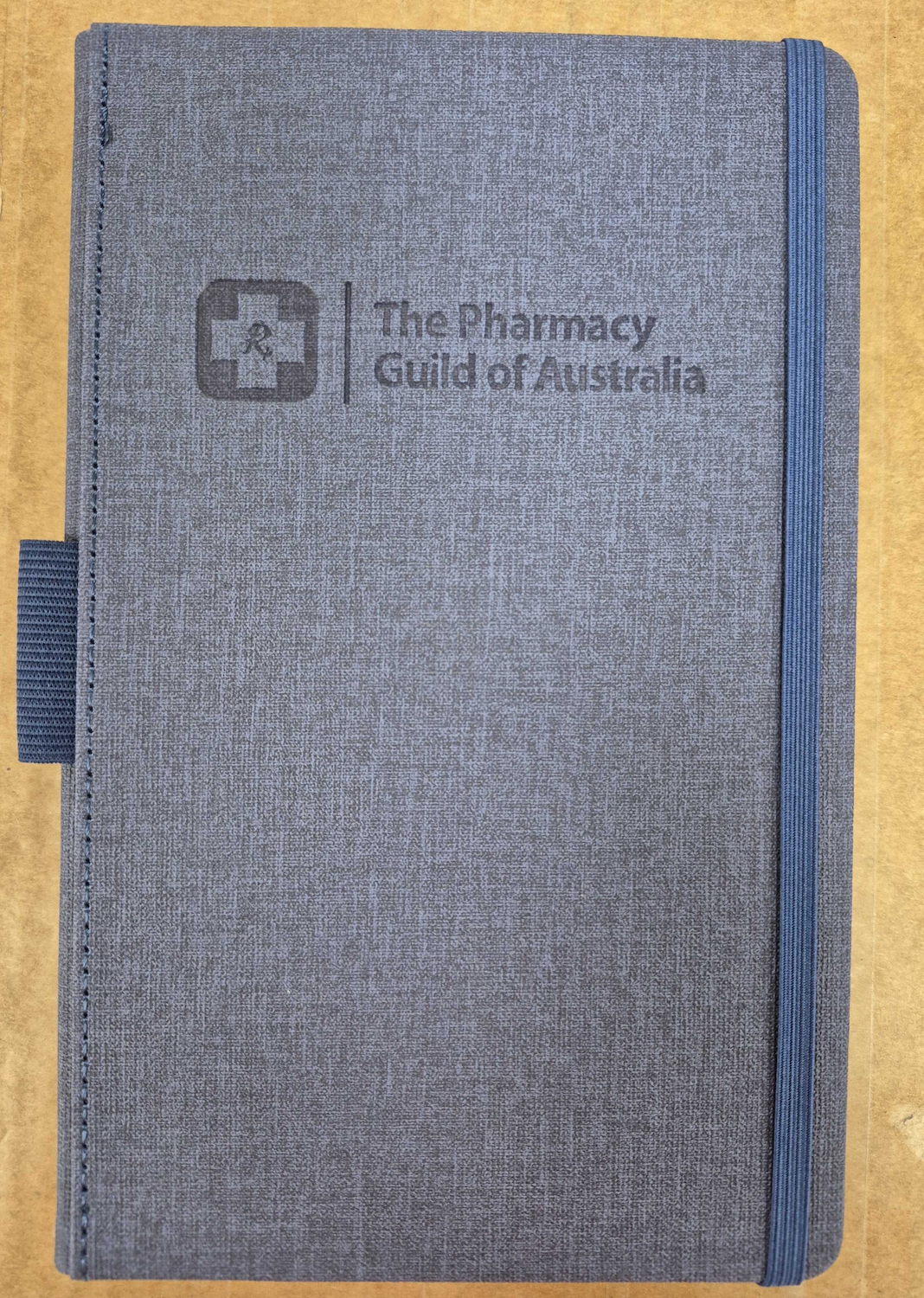 notebook with pharmacy guild of australia logo