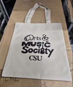 white tote bag with arts and music society csu logo