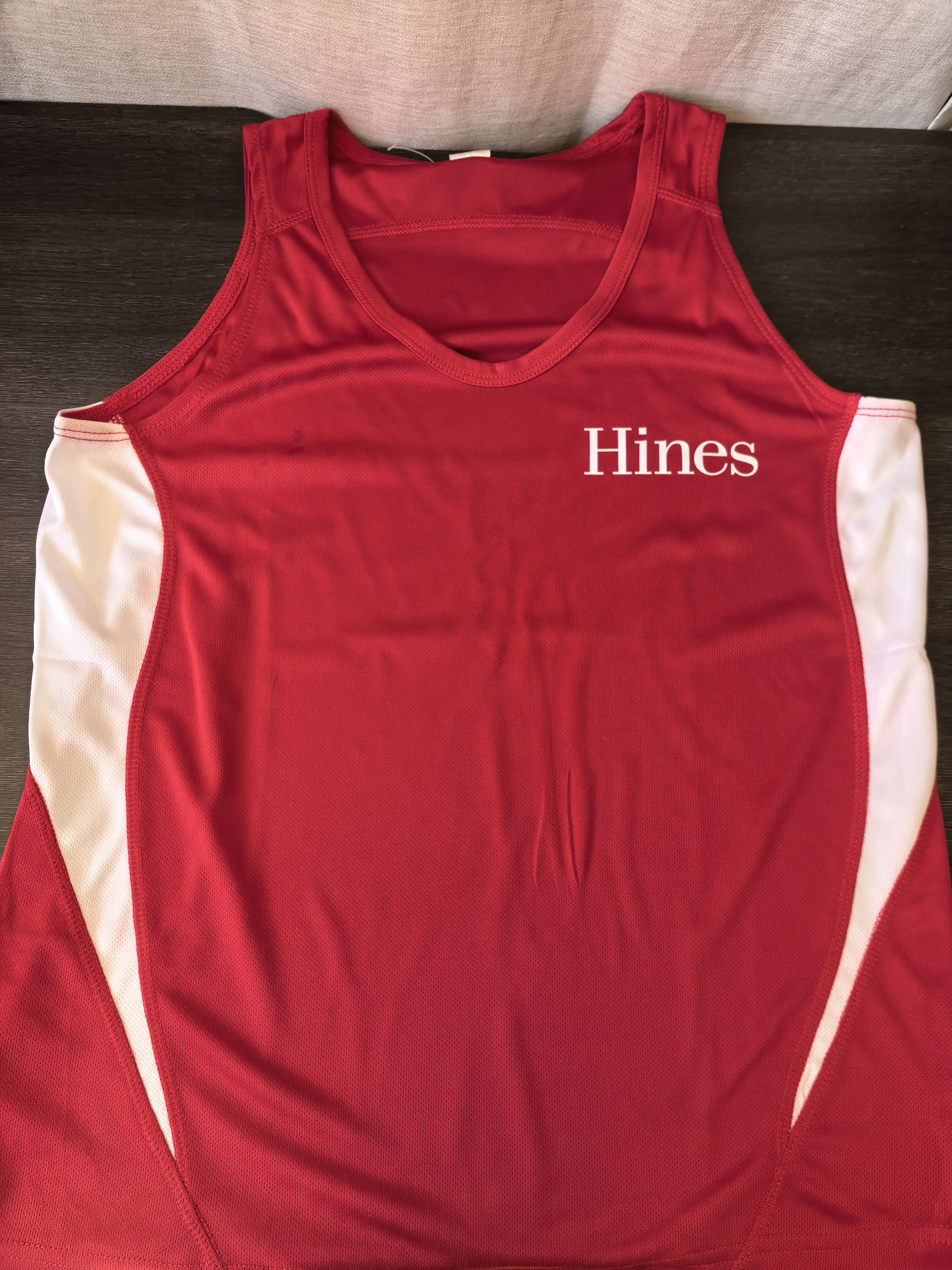 red singlet branded with Hines logo