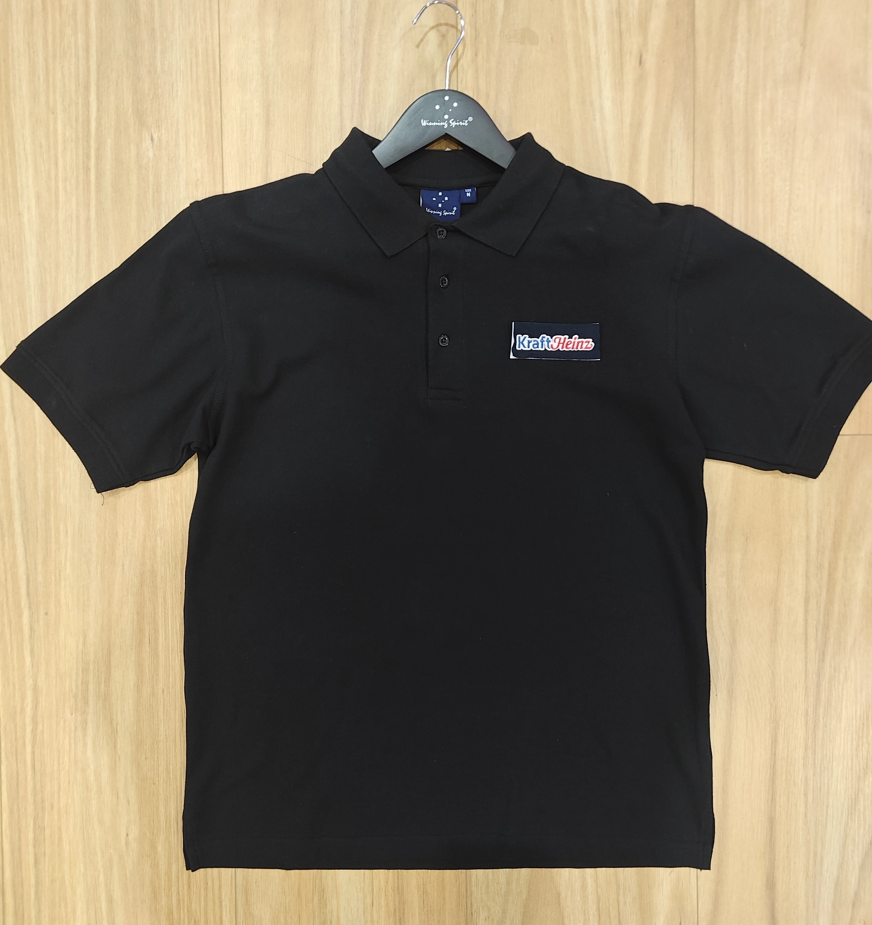 black polo shirt branded with Kraft Heinz logo