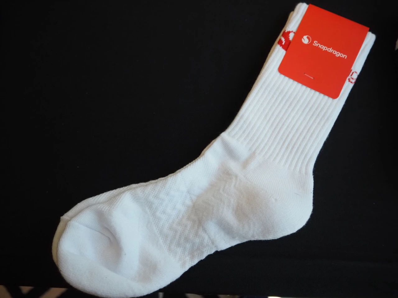 white sock with logo on the upper part and the label
