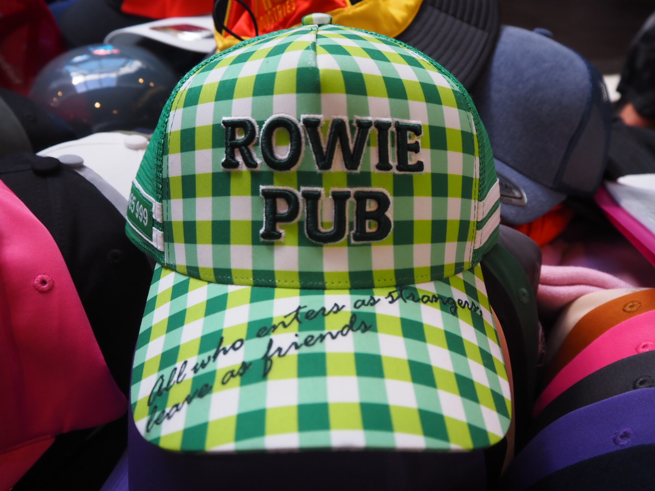 green and white cap with rowie club logo