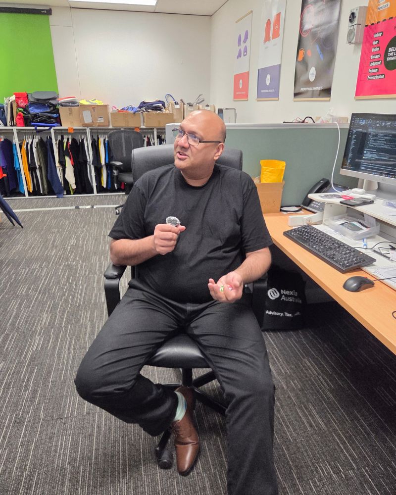 anil in the office sitting with a mic