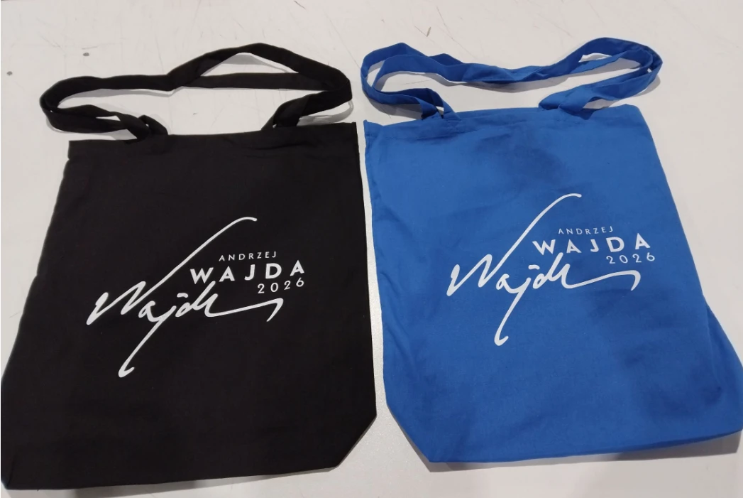 black and blue tote bags branded with WAJDA 2026 text