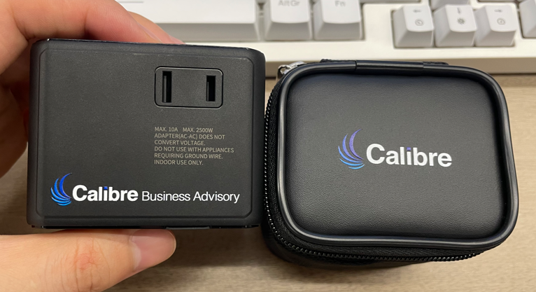 black travel adapter with pouch customised with Calibre logo