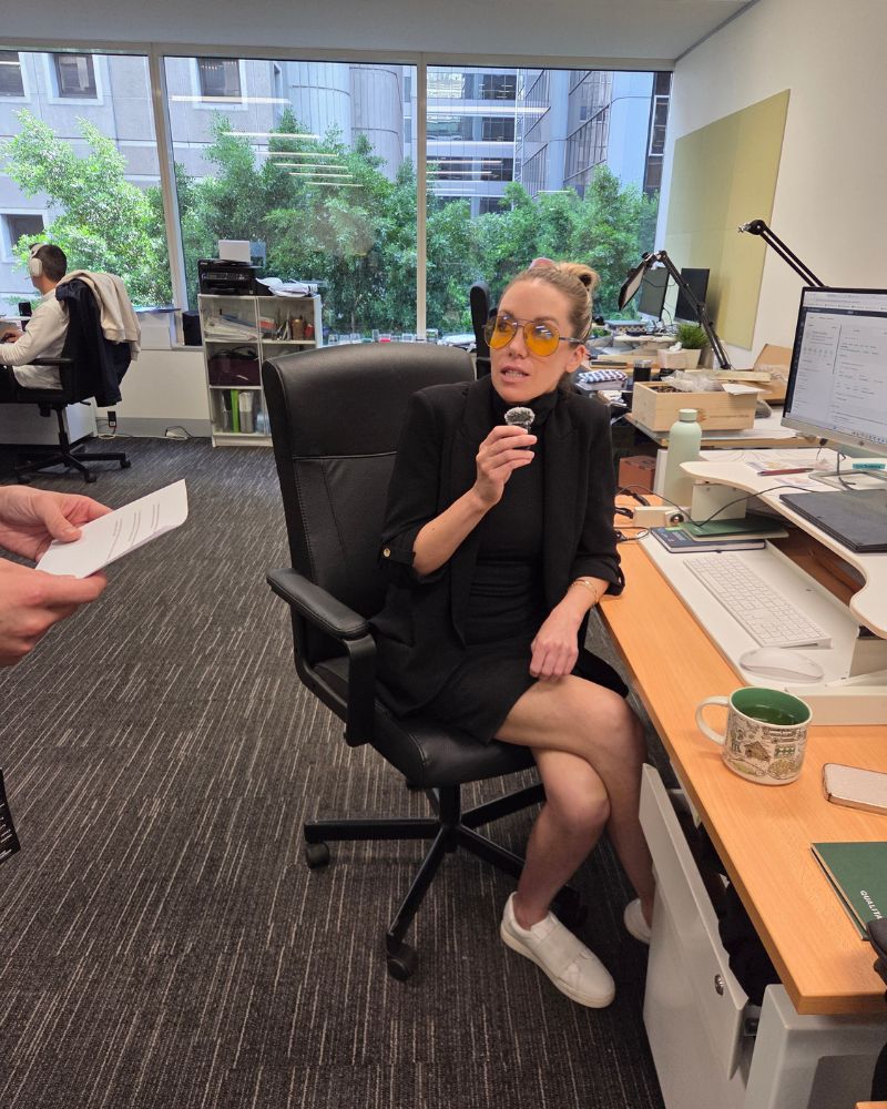 katherine holding a microphone while sitting