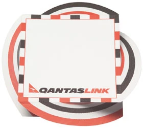 A stack of QantasLink-branded notepaper with a red, black, and white border design.