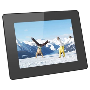 Two people doing cartwheels on snow with mountains and a lake in the background.
