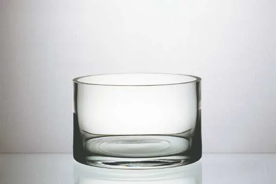 A clear, empty glass bowl on a white background.