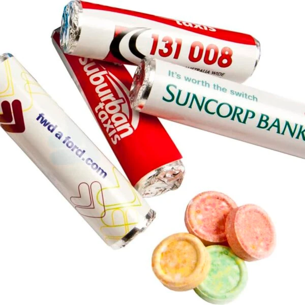 Three labeled candy rolls and four round, colorful candies on a white background.
