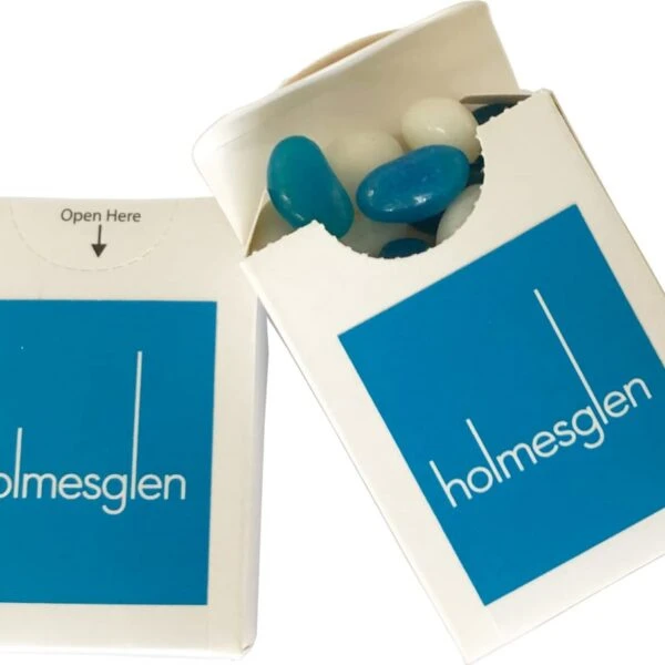 Two small boxes labeled holmesglen with blue and white candy-coated mints inside.