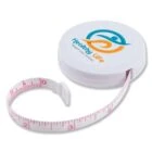 White round tape measure with Healthy Life Weight Loss Center logo in blue and orange on the case. The measuring tape is partially extended, showing pink centimeter markings.