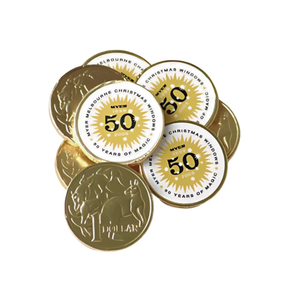 A pile of Customised Chocolate Gold Coins celebrating the Myer Melbourne Christmas Windows 50 Years of Magic 2006 with a sunburst design, featuring a large 50 in the center and a dollar symbol on the reverse.