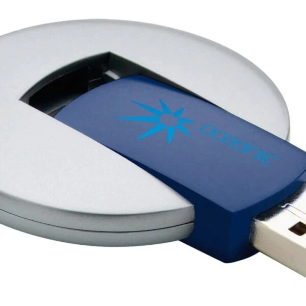 A round, silver USB drive with a blue center is partially extended from its circular casing. The blue part features a star-like logo and the word Oceanic. The USB connector is visible at the end.
