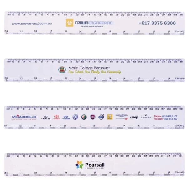 Four white plastic rulers, each featuring different printed logos and contact details for Crown Engineering, Marist College Penshurst, MacCarrolls dealership, and Pearsall Primary School. Each ruler measures up to 31 centimeters or 12 inches.