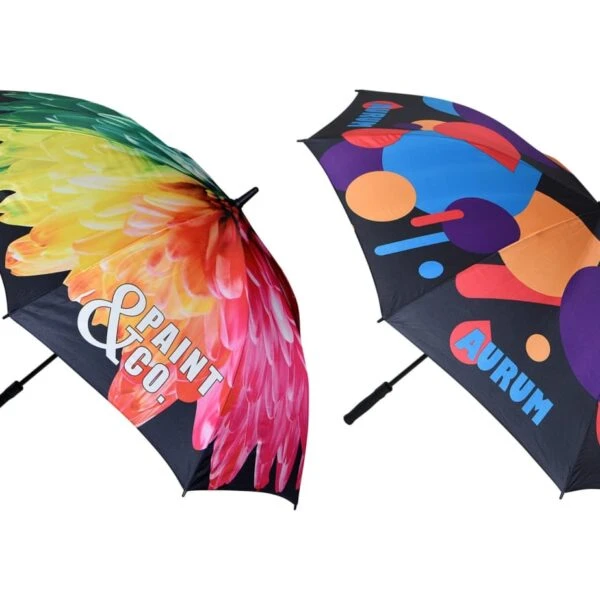 Two umbrellas with colorful, bold graphic designs and black handles on a white background.