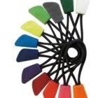 Ten colorful climbing nuts attached to black cables, fanned out in a circle.