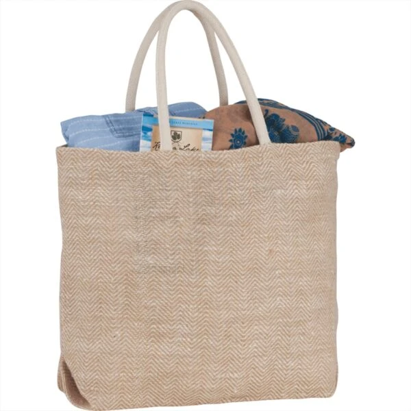 A beige woven tote bag filled with patterned fabric items.