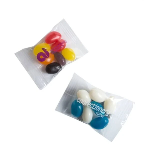 Two small clear packets, each containing colorful jelly beans on a white background.