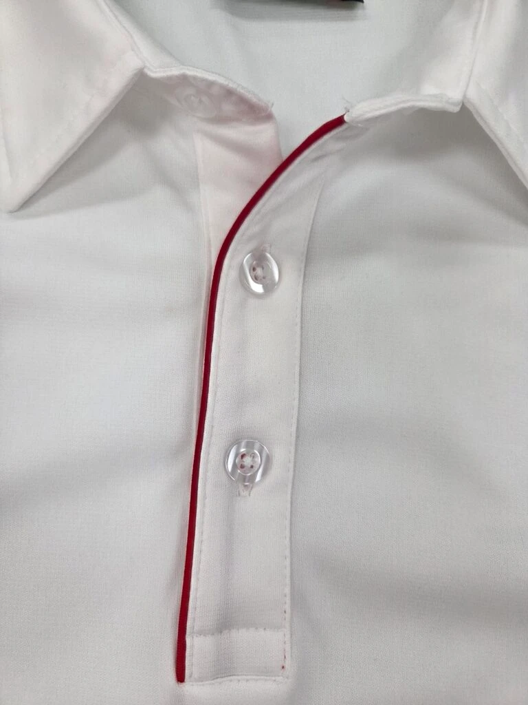 collar part of a white polo shirt with red lining.